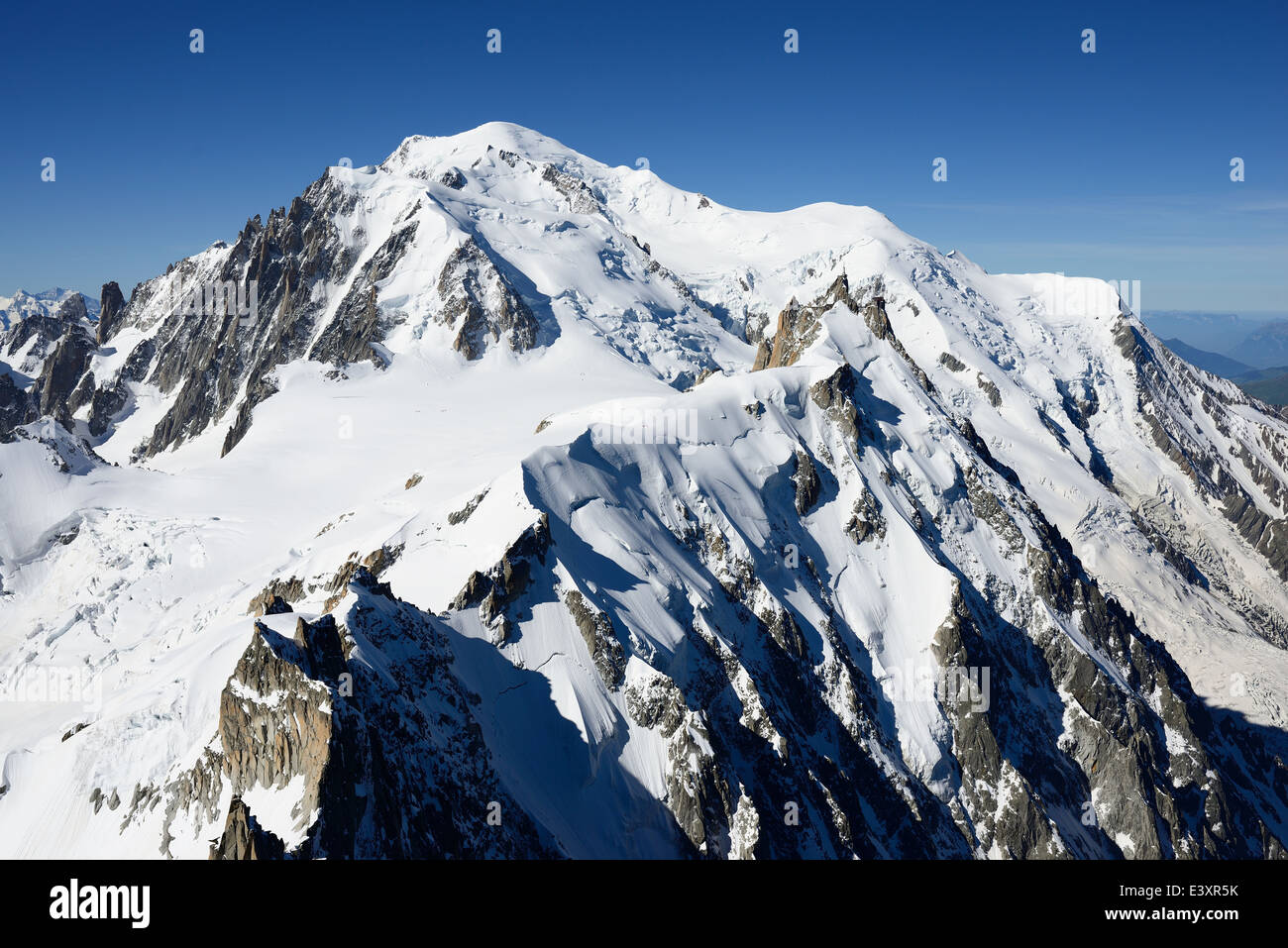 AERIAL VIEW. Aiguille du Midi (elevation: 3842m) and Mont-Blanc (elevation: 4810m). Chamonix Mont-Blanc, Haute-Savoie, Auvergne-Rhône-Alpes, France. Stock Photo