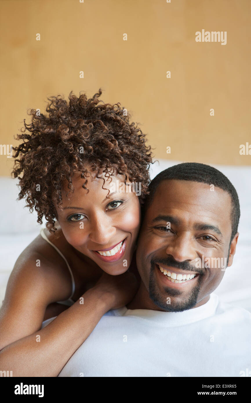 African American couple relaxing on bed Stock Photo - Alamy