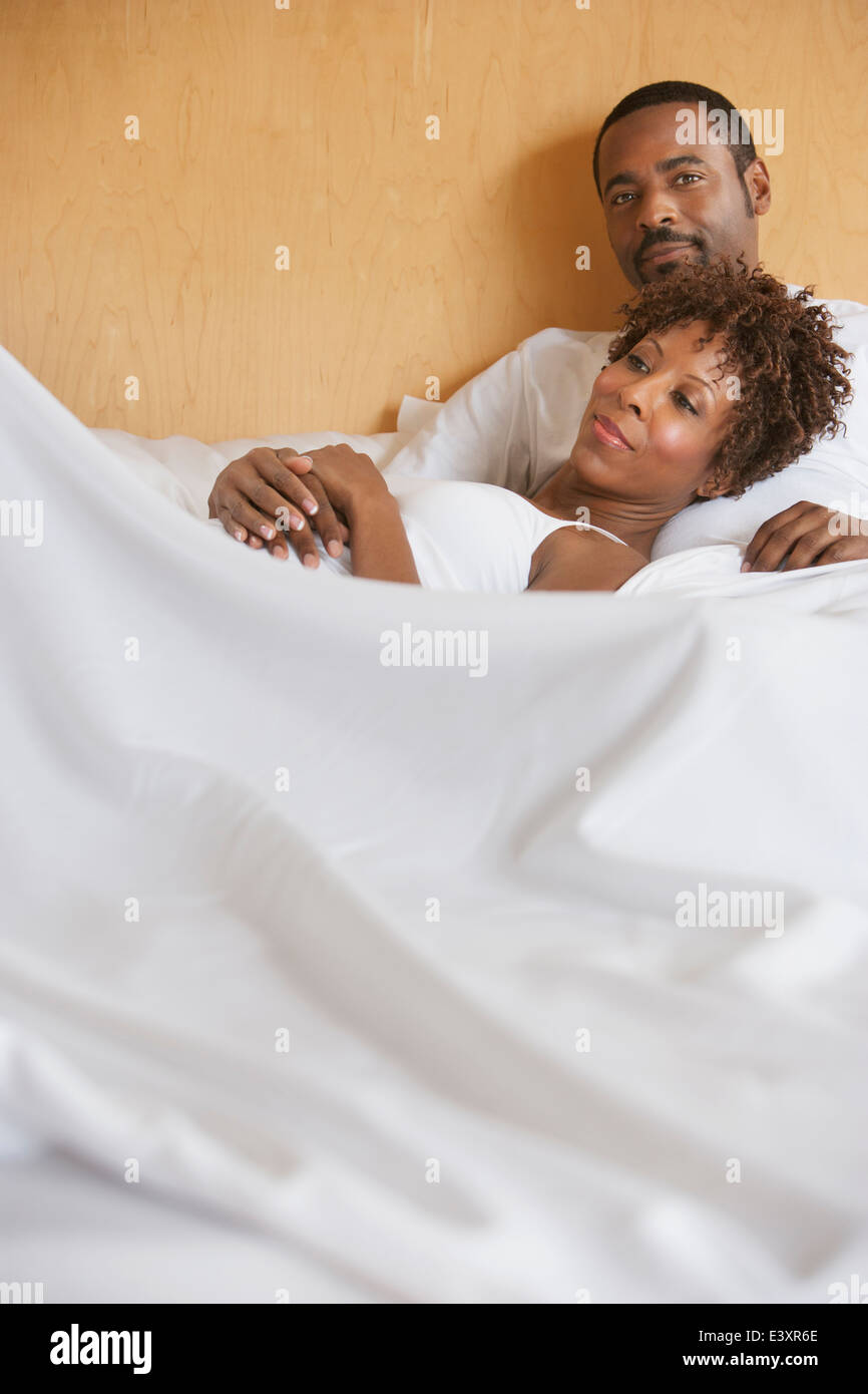 African American couple relaxing in bed Stock Photo - Alamy
