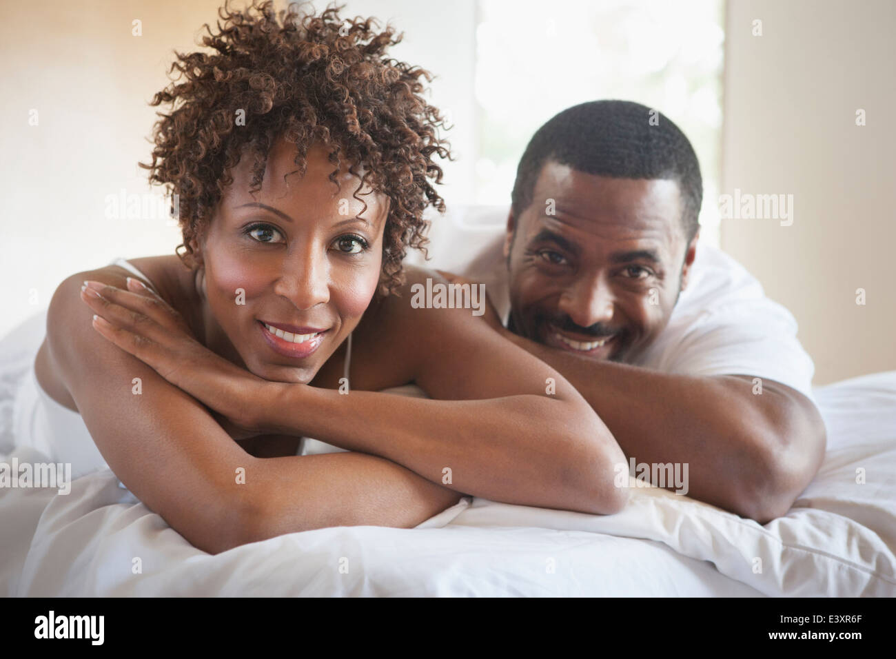 African American couple relaxing in bed Stock Photo - Alamy