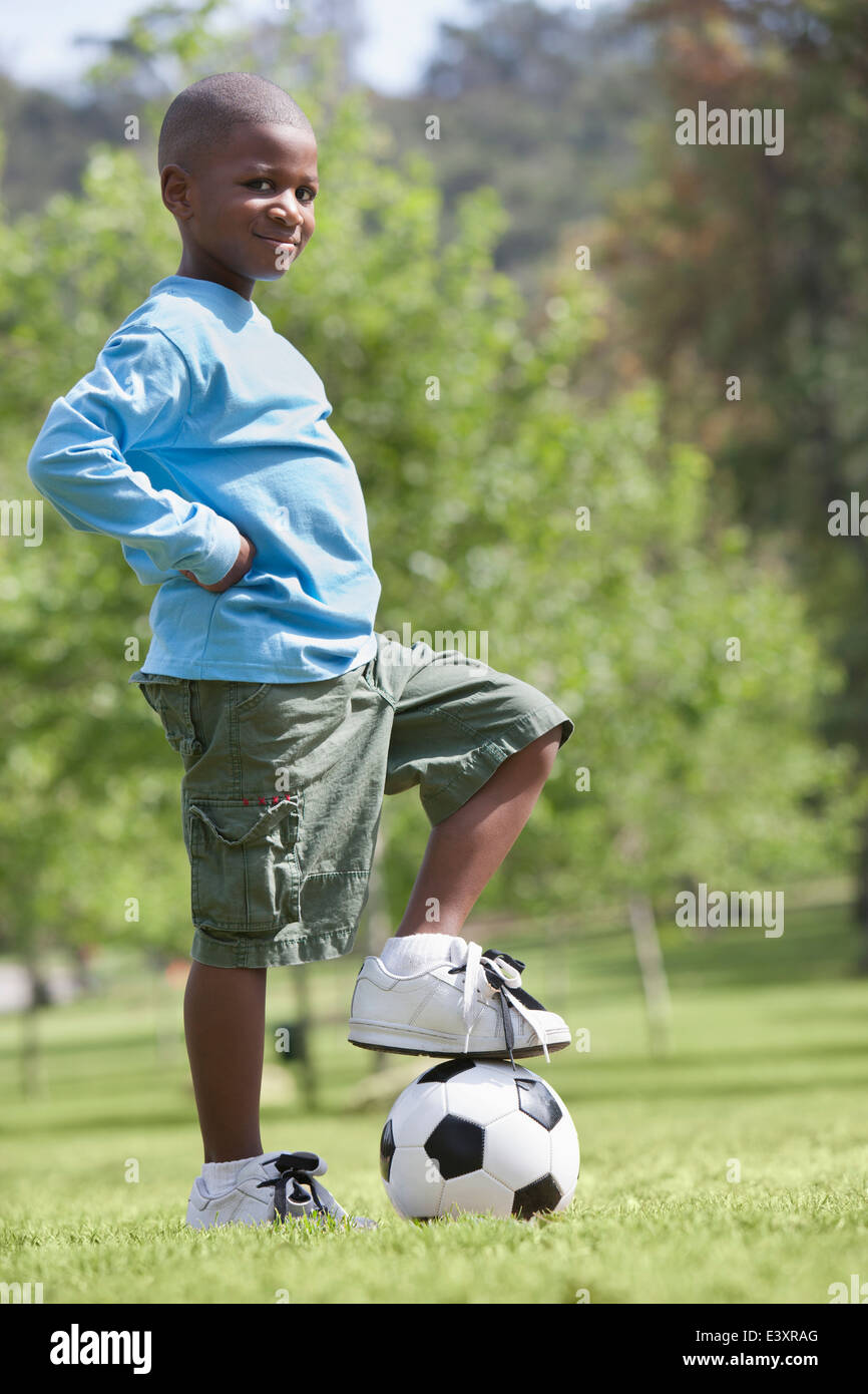 African American boy playing soccer in park Stock Photo - Alamy