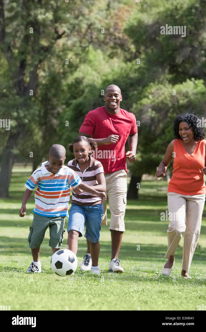 Family playing soccer in park Stock Photo - Alamy