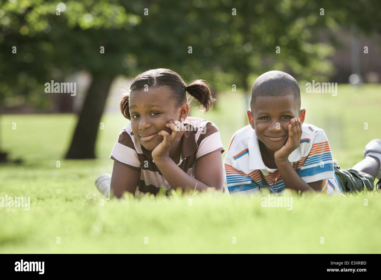 African American children laying in park Stock Photo - Alamy