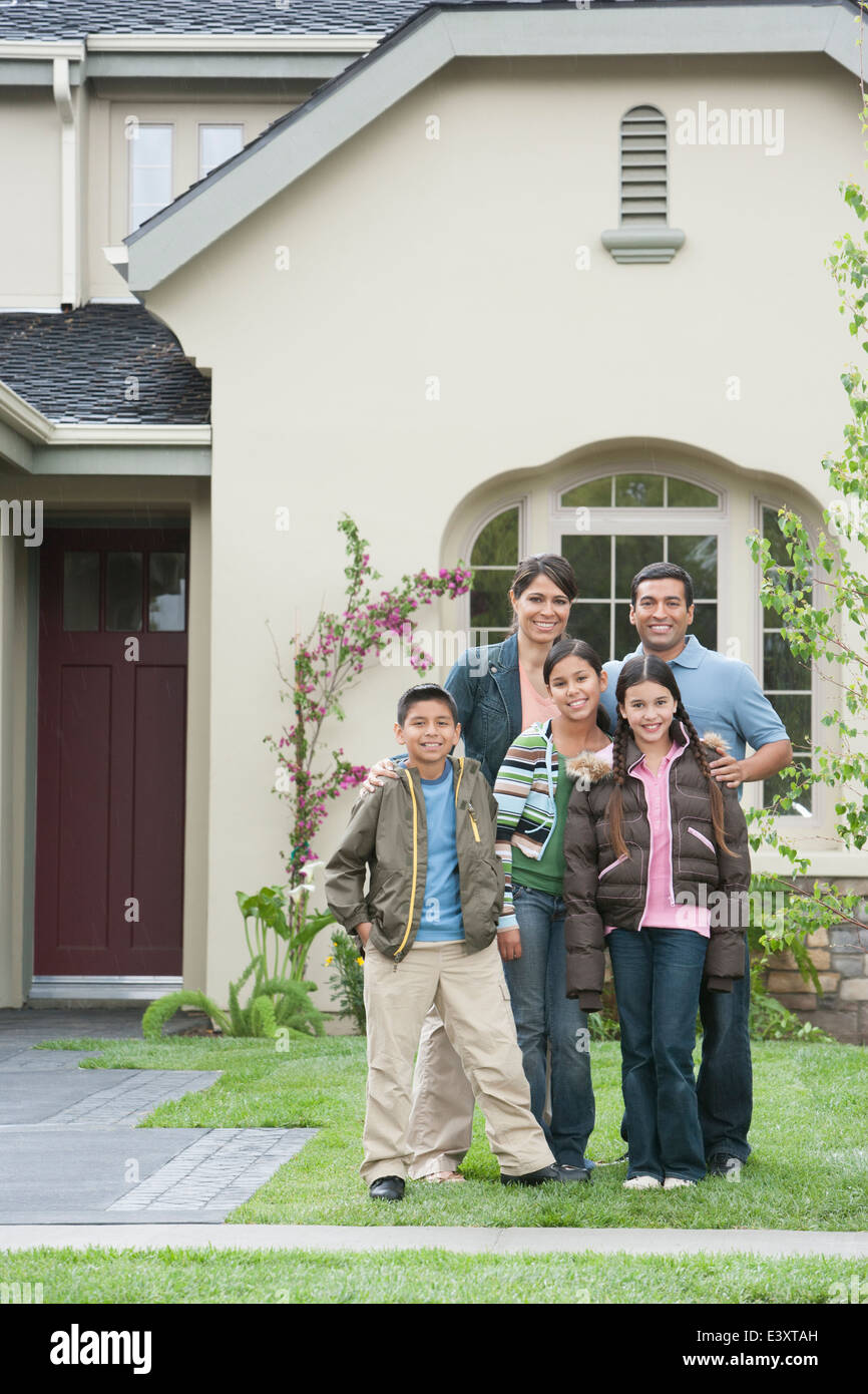 Hispanic family smiling outside home Stock Photo - Alamy