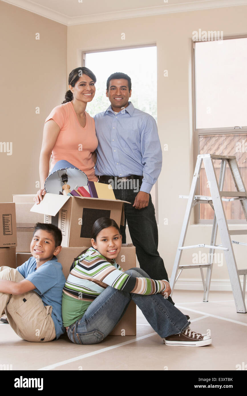 Hispanic family smiling in new home Stock Photo - Alamy