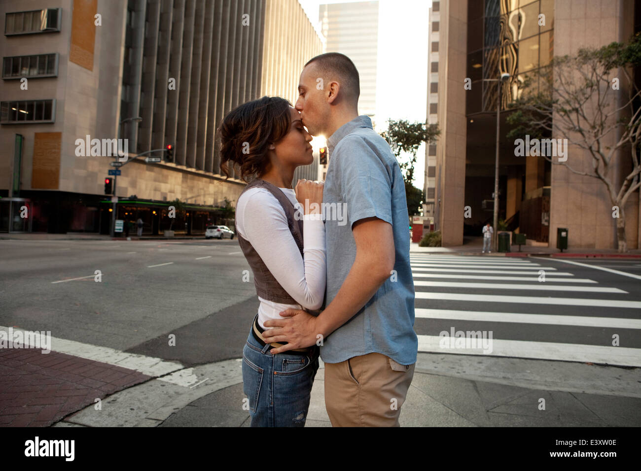 Couple kissing on city street Stock Photo