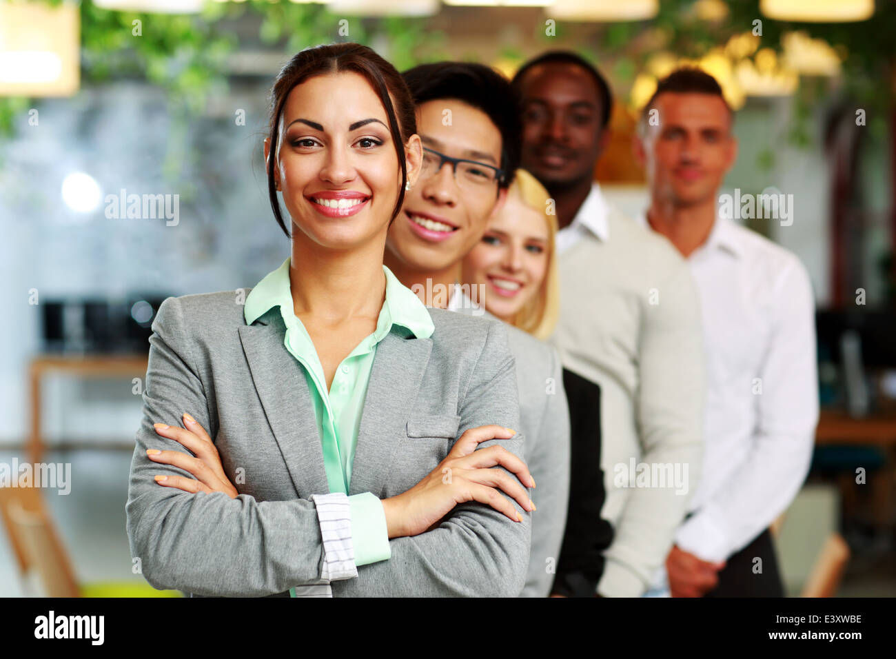 Happy group of business people in the office lined up Stock Photo - Alamy