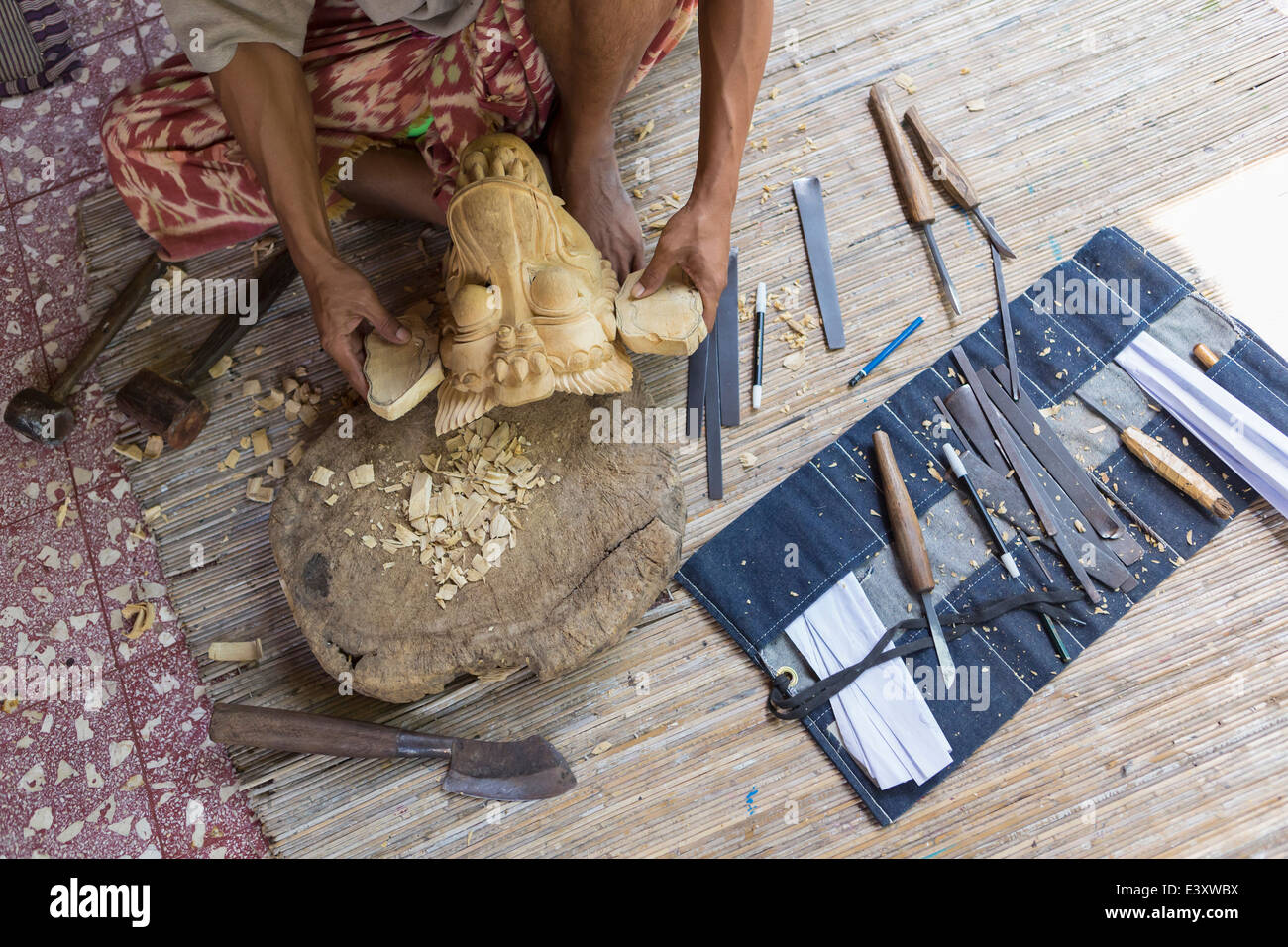 Craftsperson shaping wooden piece in studio Stock Photo
