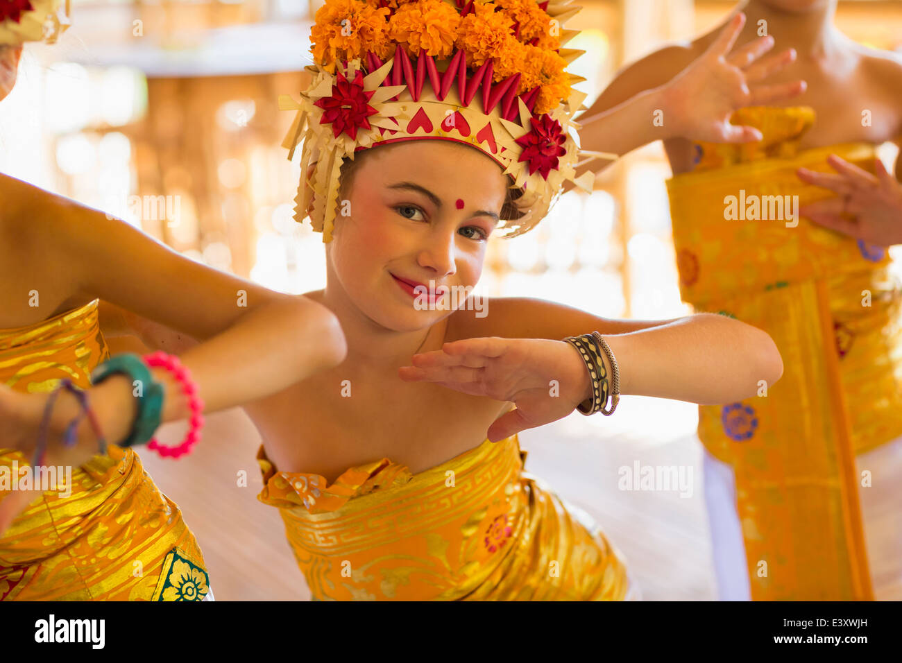 Caucasian girl dancing in traditional Balinese clothing Stock Photo