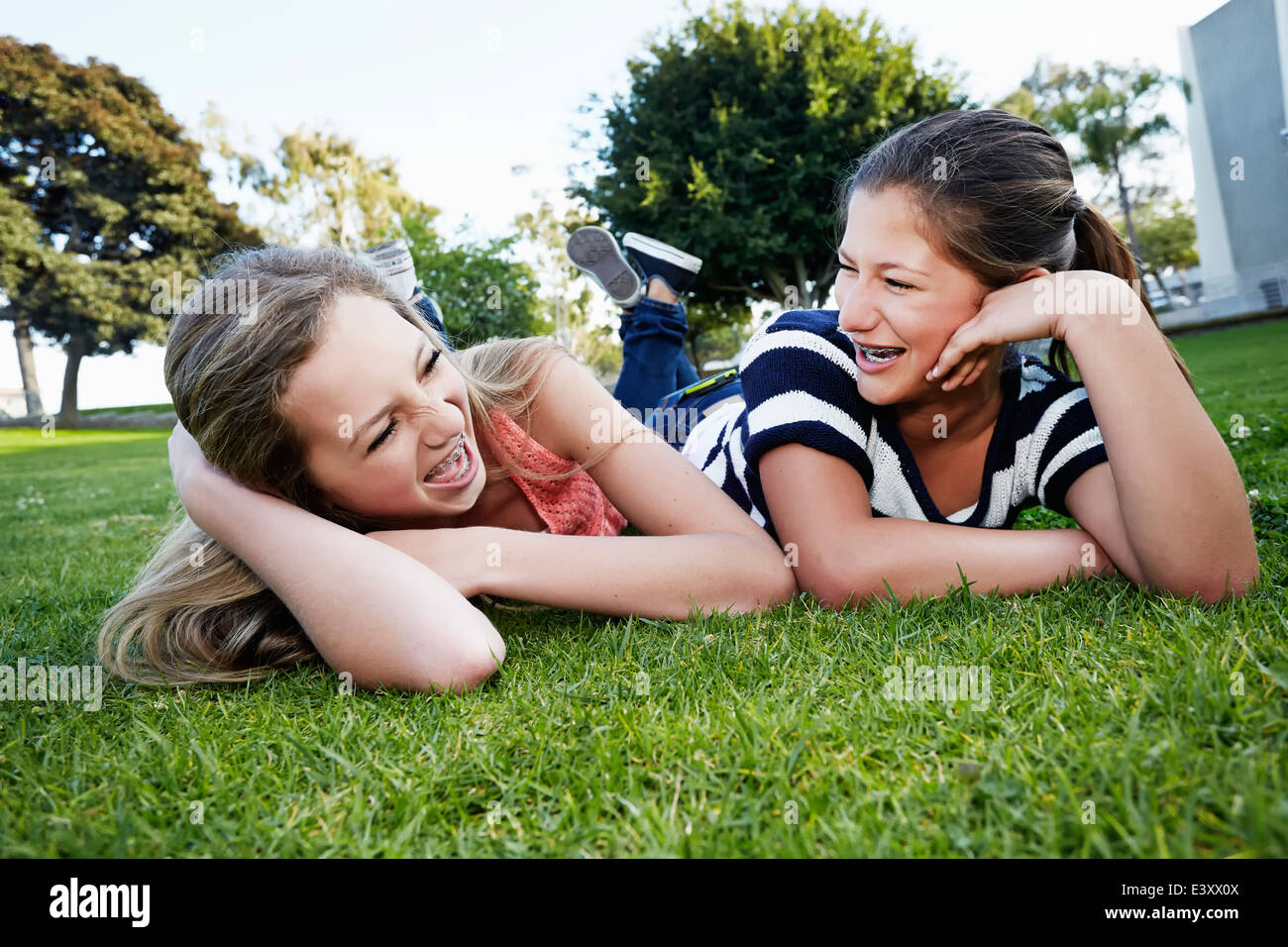 Teenage girls laying in grass Stock Photo