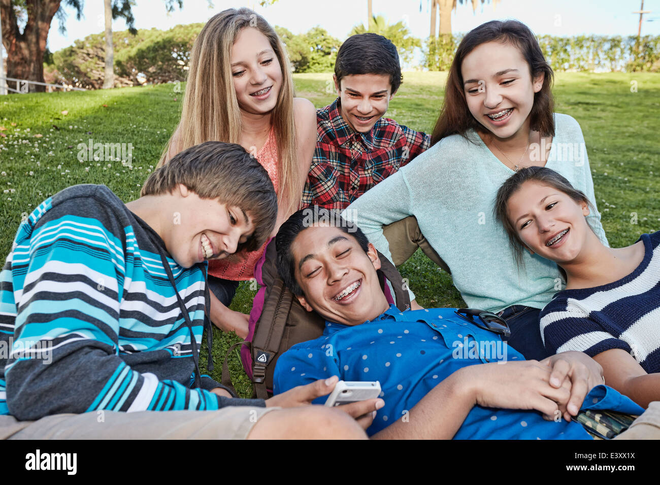 Teenagers relaxing together in grass Stock Photo