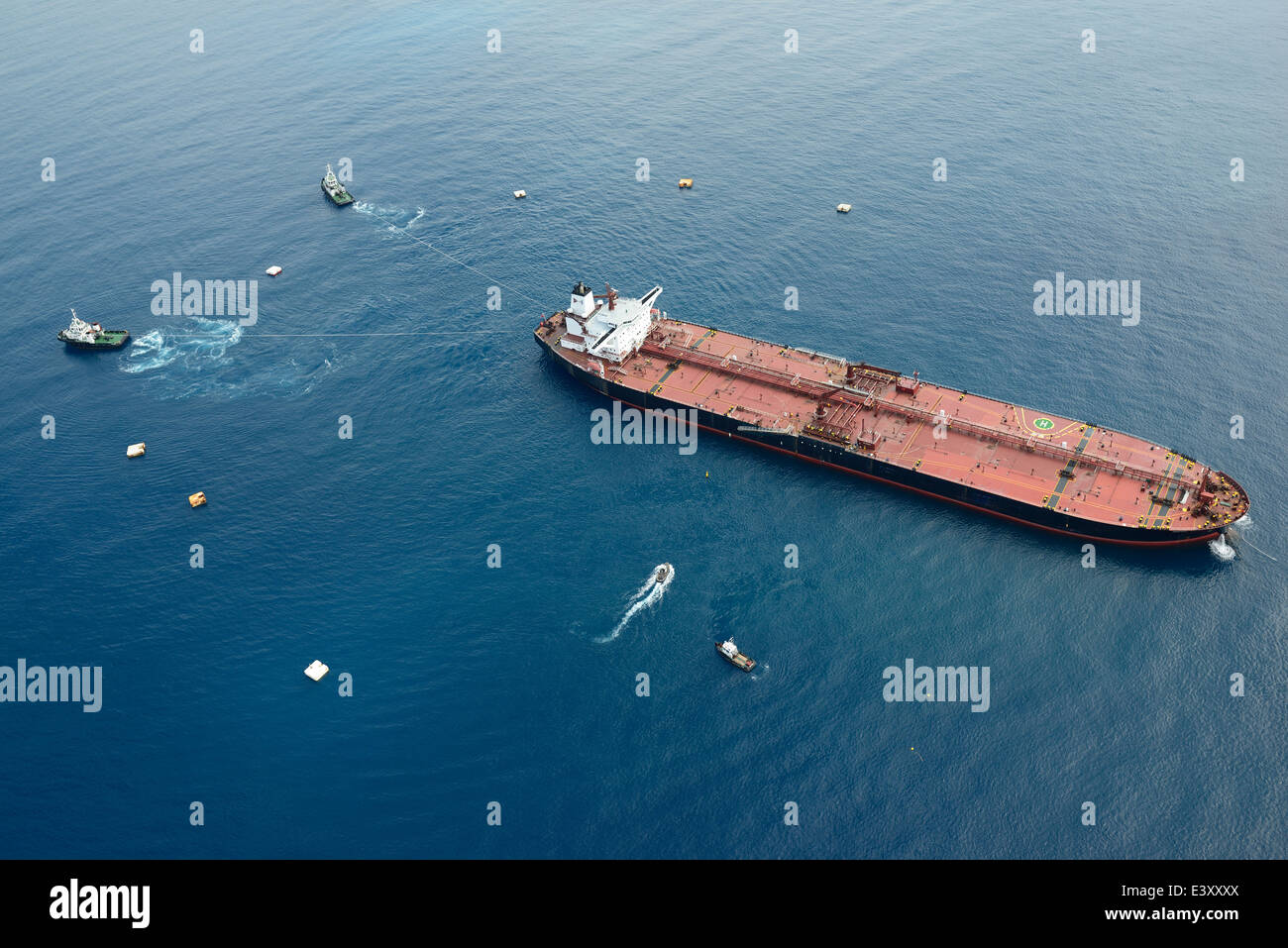 AERIAL VIEW. Supertanker in tow offshore near Vado Ligure. Savona, Province of Savona, Liguria, Italy. Stock Photo