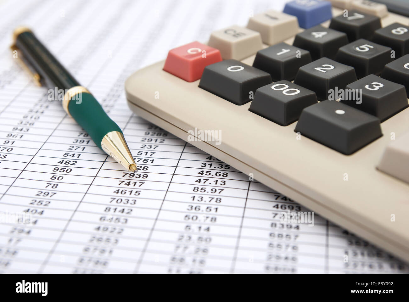 calculator & pen on a chart background Stock Photo - Alamy