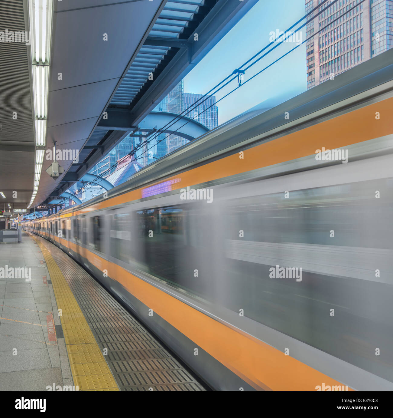 Blurred view of train leaving platform, Tokyo, Japan Stock Photo