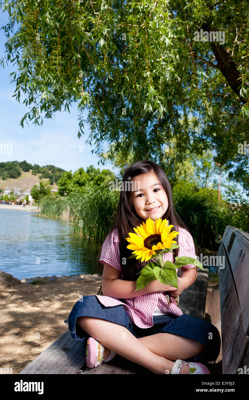 Girl holding sunflower Stock Photo - Alamy