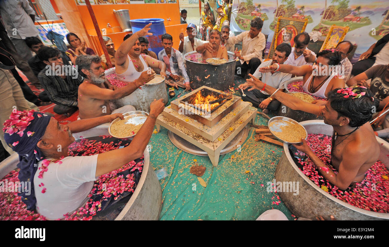 Ahmadabad, India. 1st July, 2014. Indian priests sitting in vessels ...