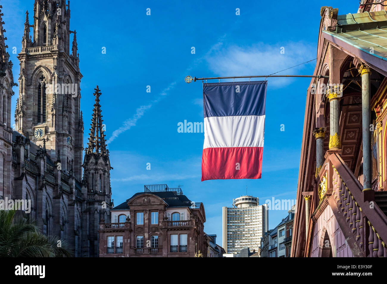 French flag at old City hall and St Etienne temple and Tour de l'Europe tower in the distance Mulhouse Alsace France Europe Stock Photo