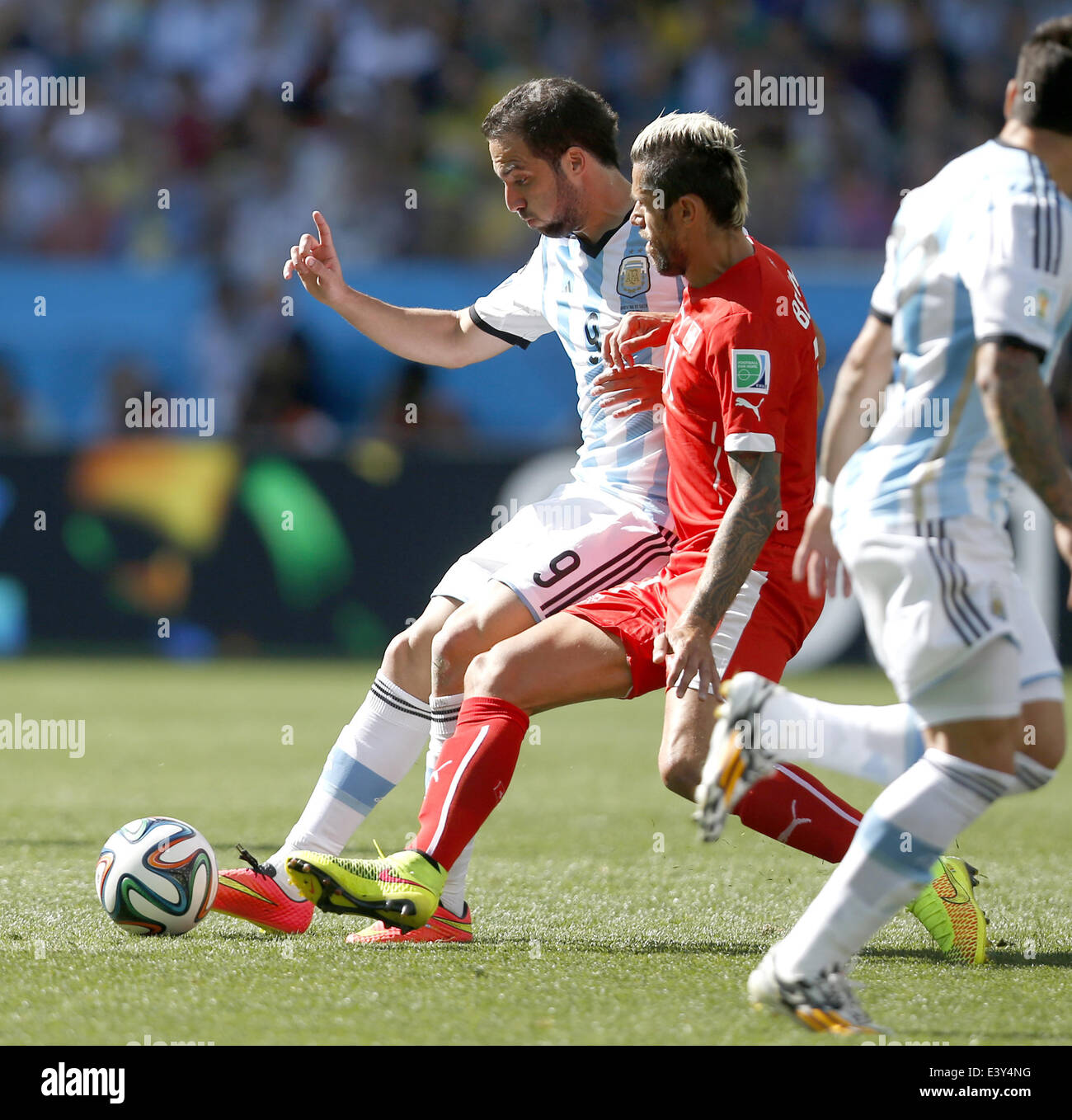 Sao Paulo, Brazil. 1st July, 2014. Argentina's Gonzalo Higuain (L) vies with Switzerland's Valon Behrami (C) during a Round of 16 match between Argentina and Switzerland of 2014 FIFA World Cup at the Arena de Sao Paulo Stadium in Sao Paulo, Brazil, on July 1, 2014. Credit:  Wang Lili/Xinhua/Alamy Live News Stock Photo