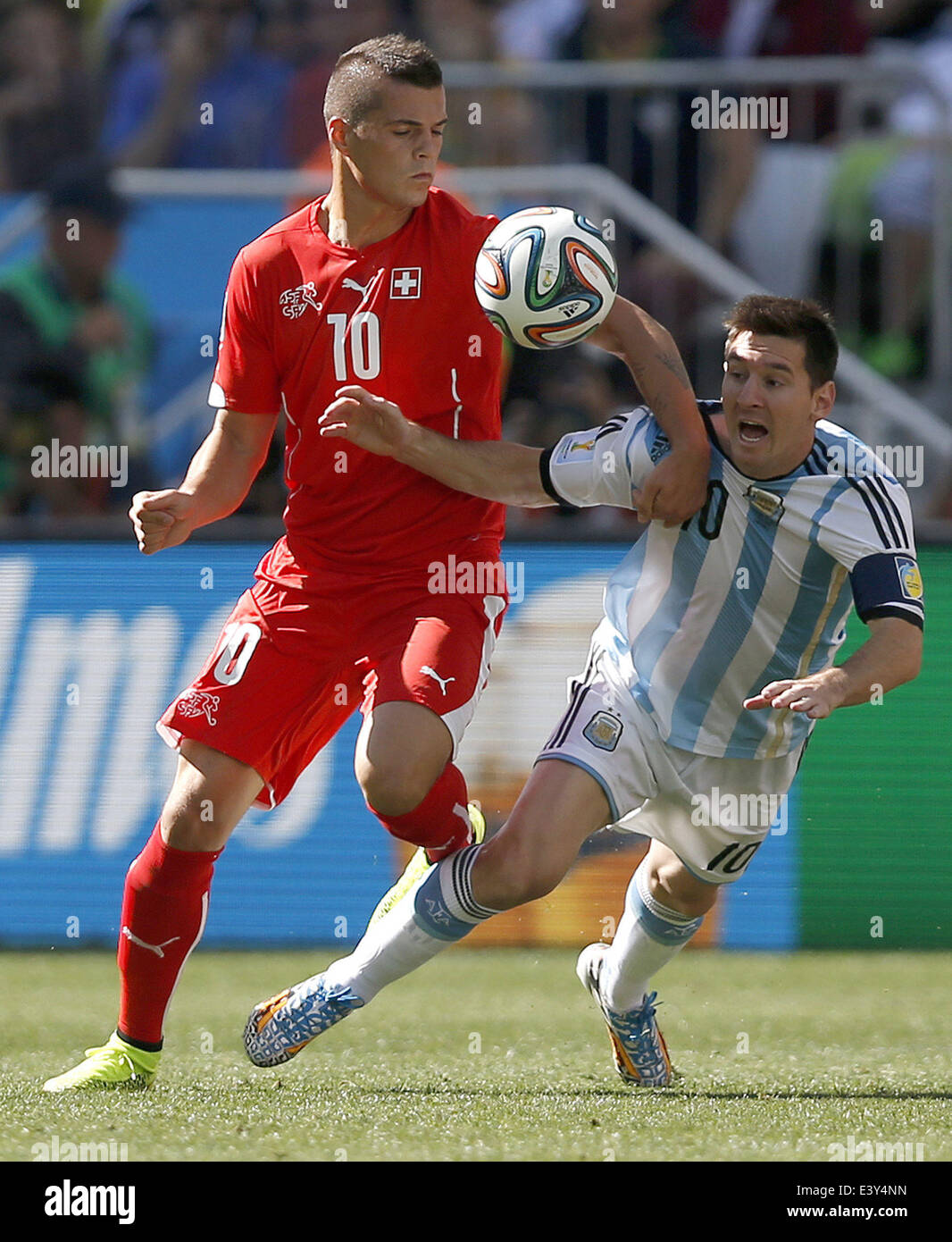 Sao Paulo, Brazil. 1st July, 2014. Switzerland's Granit Xhaka (L) vies with Argentina's Lionel Messi during a Round of 16 match between Argentina and Switzerland of 2014 FIFA World Cup at the Arena de Sao Paulo Stadium in Sao Paulo, Brazil, on July 1, 2014. Credit:  Wang Lili/Xinhua/Alamy Live News Stock Photo