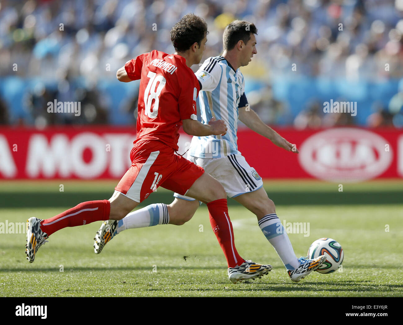 Sao Paulo, Brazil. 1st July, 2014. Switzerland's Admir Mehmedi (L) vies with Argentina's Lionel Messi during a Round of 16 match between Argentina and Switzerland of 2014 FIFA World Cup at the Arena de Sao Paulo Stadium in Sao Paulo, Brazil, on July 1, 2014. Credit:  Wang Lili/Xinhua/Alamy Live News Stock Photo