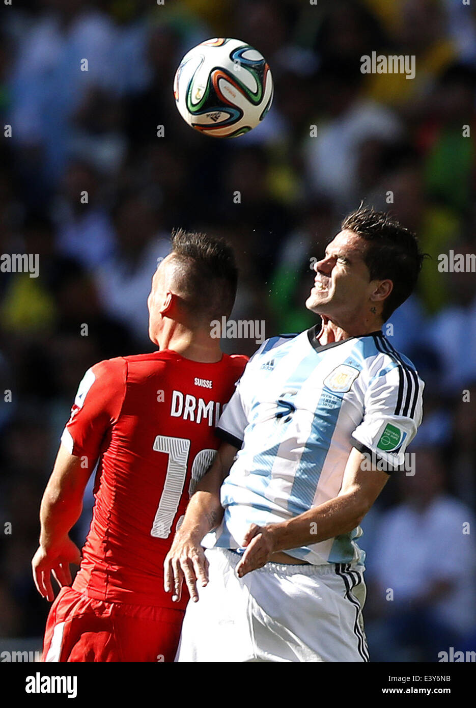 Sao Paulo, Brazil. 1st July, 2014. Switzerland's Josip Drmic (L) competes for a header with Argentina's Fernando Gago during a Round of 16 match between Argentina and Switzerland of 2014 FIFA World Cup at the Arena de Sao Paulo Stadium in Sao Paulo, Brazil, on July 1, 2014. Credit:  Wang Lili/Xinhua/Alamy Live News Stock Photo