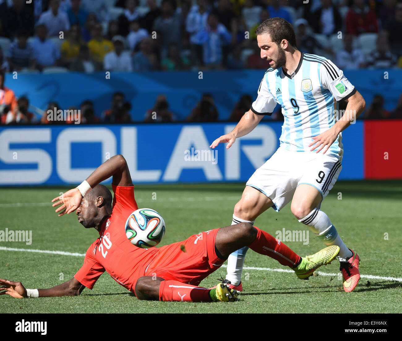 Sao Paulo, Brazil. 1st July, 2014. Argentina's Gonzalo Higuain vies with Switzerland's Johan Djourou during a Round of 16 match between Argentina and Switzerland of 2014 FIFA World Cup at the Arena de Sao Paulo Stadium in Sao Paulo, Brazil, on July 1, 2014. Credit:  Wang Yuguo/Xinhua/Alamy Live News Stock Photo