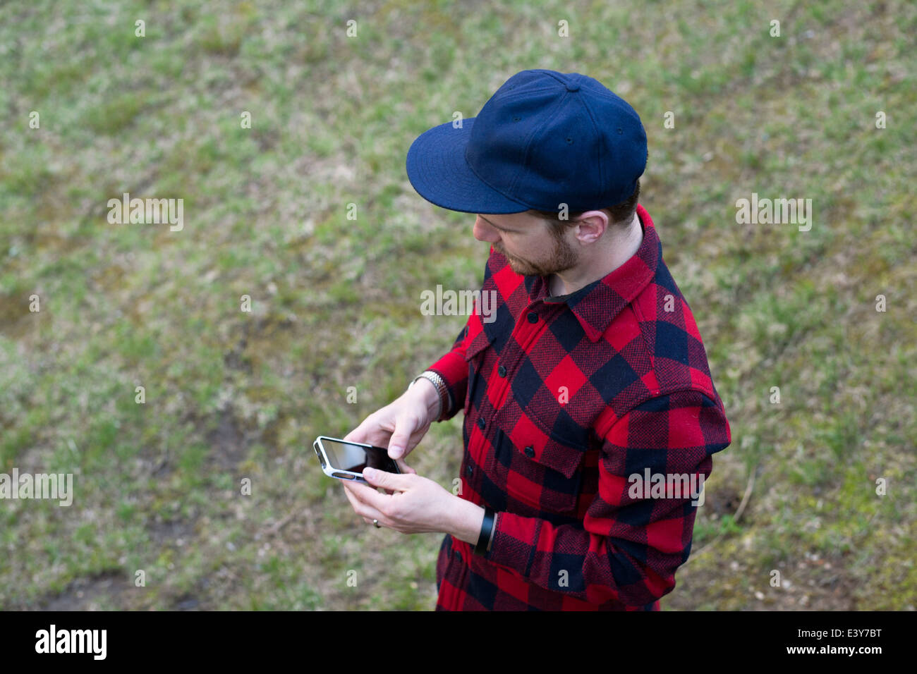 High angle view of mid adult man texting on smartphone Stock Photo - Alamy