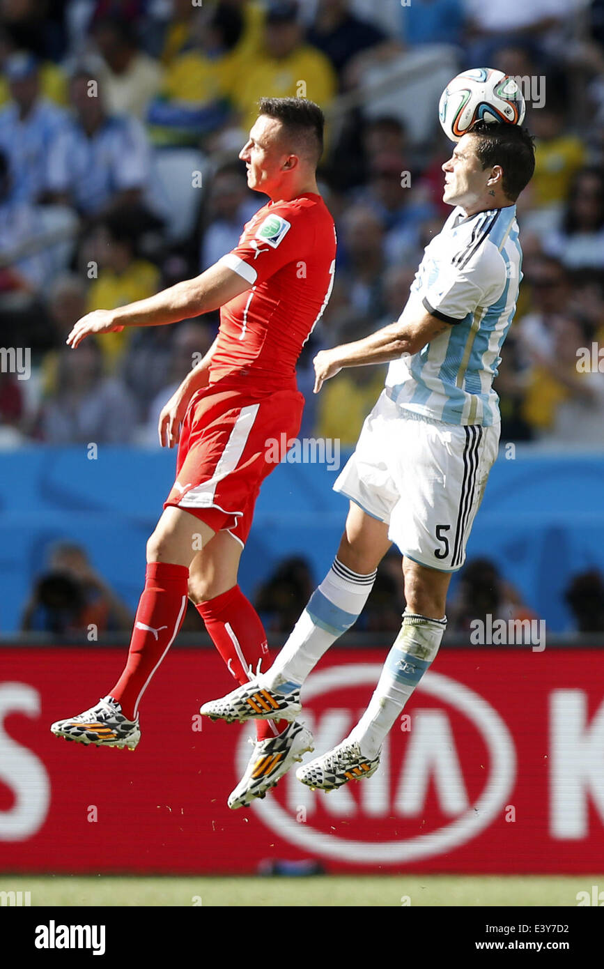 Sao Paulo, Brazil. 1st July, 2014. Argentina's Fernando Gago (R) competes for a header with Switzerland's Josip Drmic during a Round of 16 match between Argentina and Switzerland of 2014 FIFA World Cup at the Arena de Sao Paulo Stadium in Sao Paulo, Brazil, on July 1, 2014. Credit:  Wang Lili/Xinhua/Alamy Live News Stock Photo