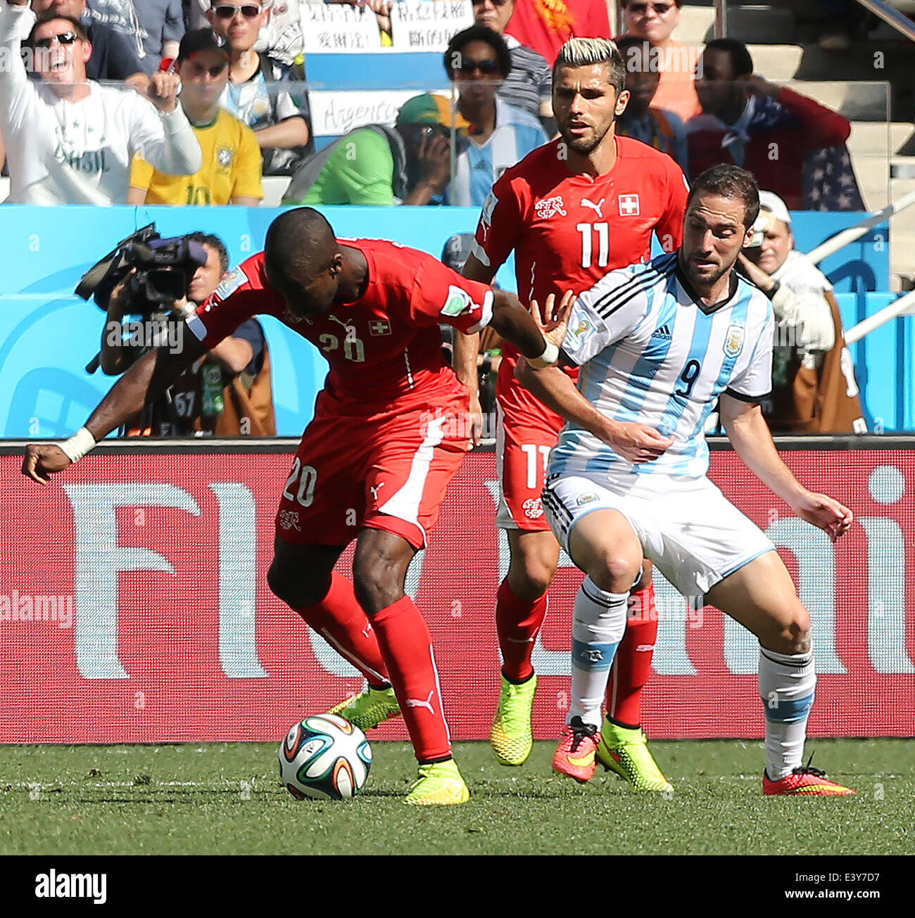 Sao Paulo, Brazil. 1st July, 2014. Argentina's Gonzalo Higuain (R) vies with Switzerland's Johan Djourou (L) during a Round of 16 match between Argentina and Switzerland of 2014 FIFA World Cup at the Arena de Sao Paulo Stadium in Sao Paulo, Brazil, on July 1, 2014. Credit:  Xu Zijian/Xinhua/Alamy Live News Stock Photo