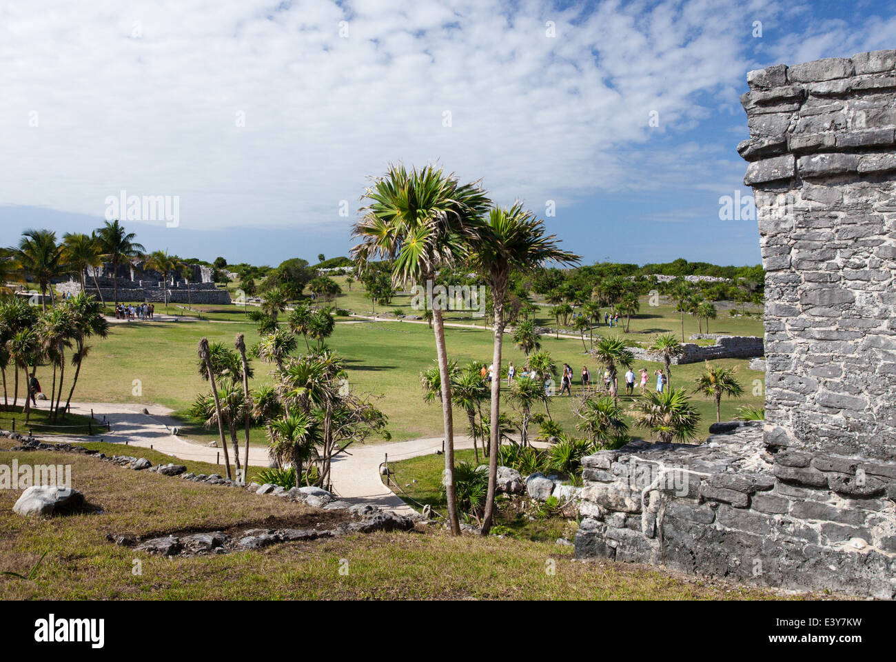 Tourist groups walk around the grounds at the Tulum archaeological site in Quintana Roo, Mexico. Stock Photo