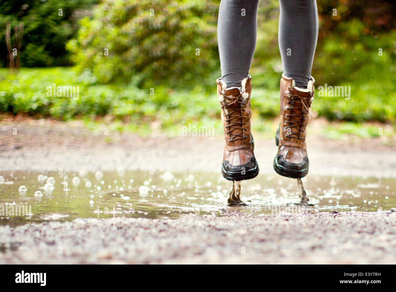 Legs and feet, jumping in puddle Stock Photo Alamy