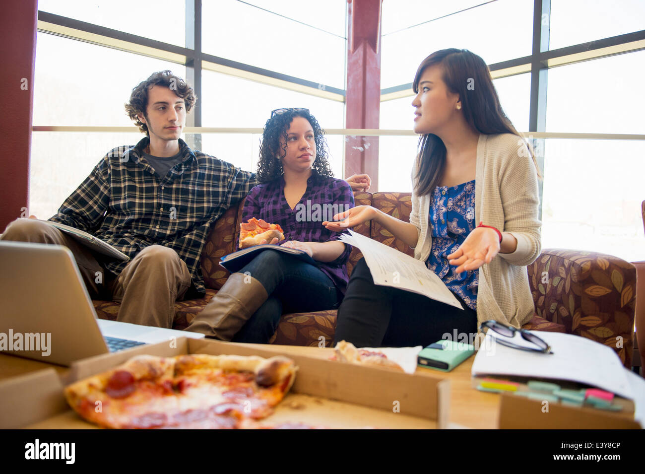 Students in common room eating pizza Stock Photo