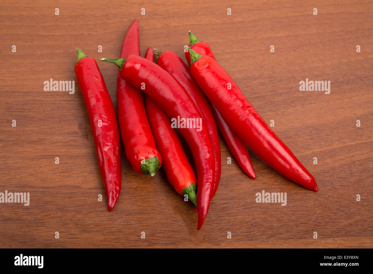 Chile peppers on the wooden table Stock Photo - Alamy