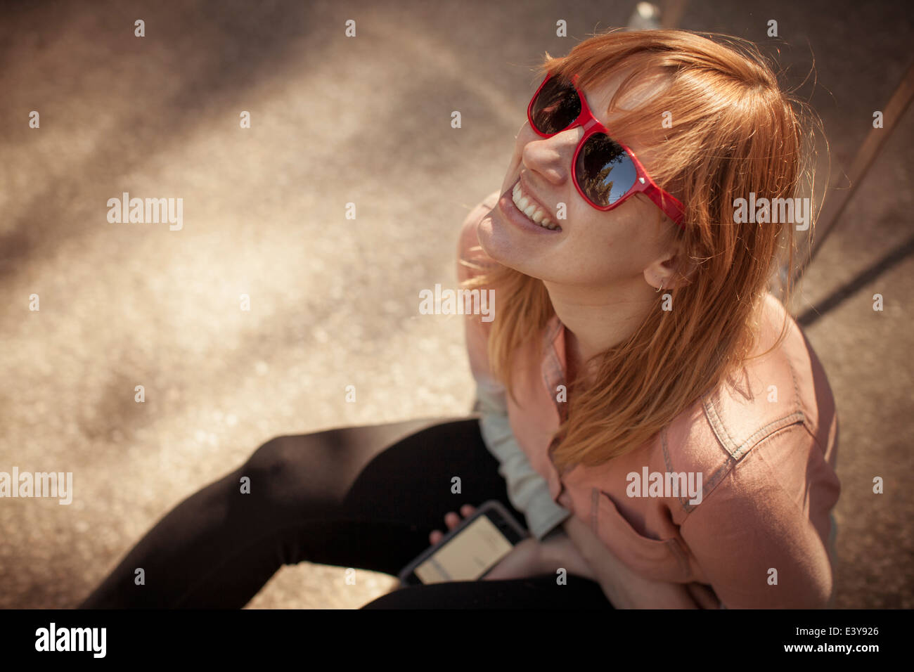 Candid portrait of mid adult woman in sunglasses gazing upward Stock Photo