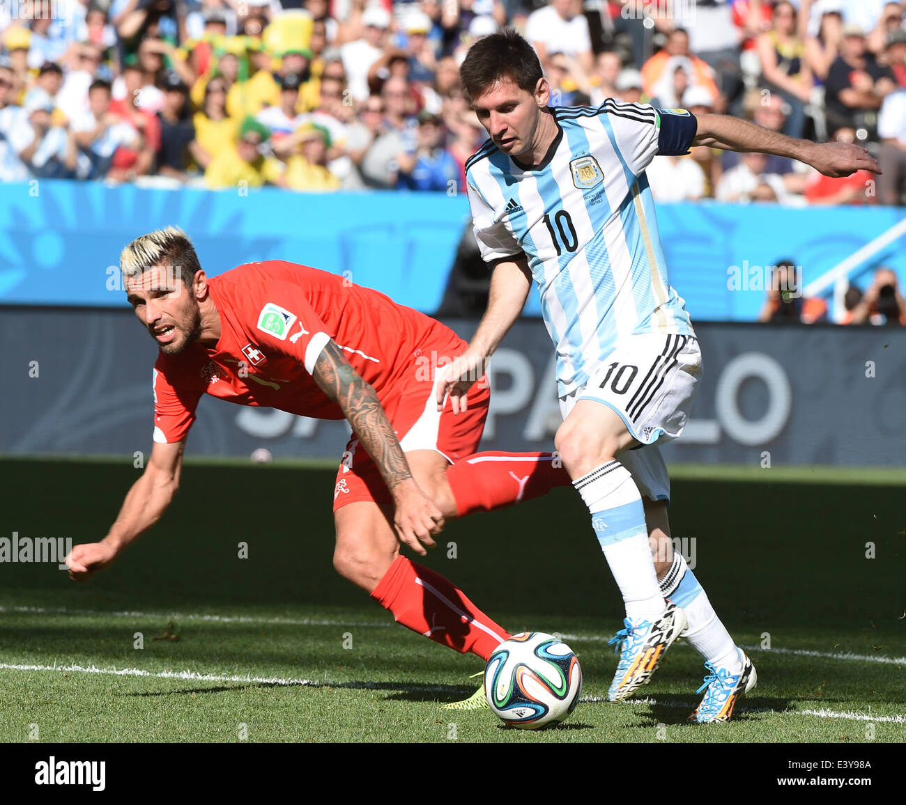 Sao Paulo, Brazil. 1st July, 2014. Argentina's Lionel Messi vies with Switzerland's Valon Behrami during a Round of 16 match between Argentina and Switzerland of 2014 FIFA World Cup at the Arena de Sao Paulo Stadium in Sao Paulo, Brazil, on July 1, 2014. Credit:  Wang Yuguo/Xinhua/Alamy Live News Stock Photo