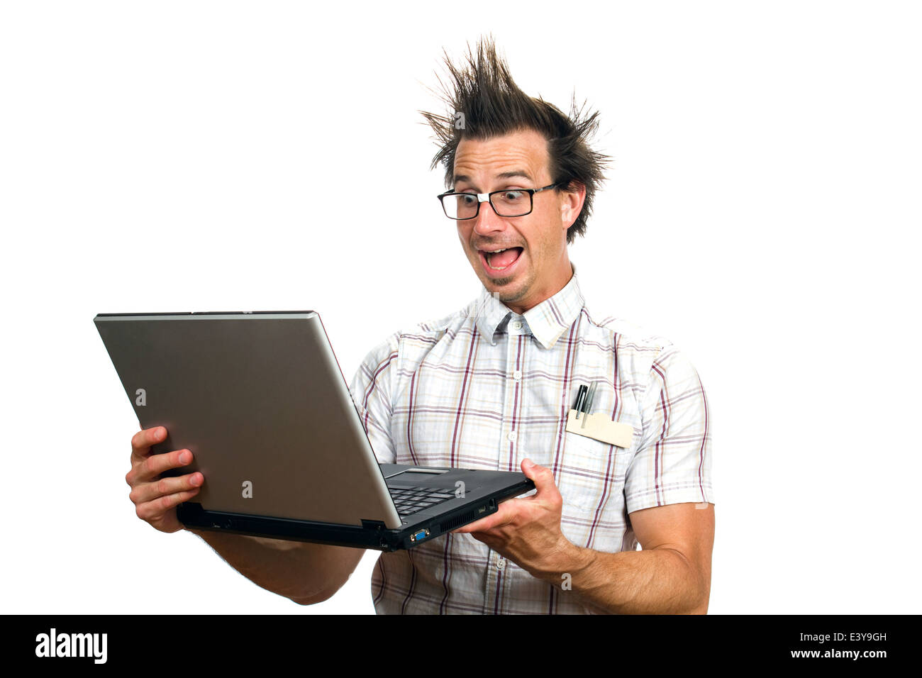 Computer nerd gets frightened viewing the internet on a laptop screen. Stock Photo