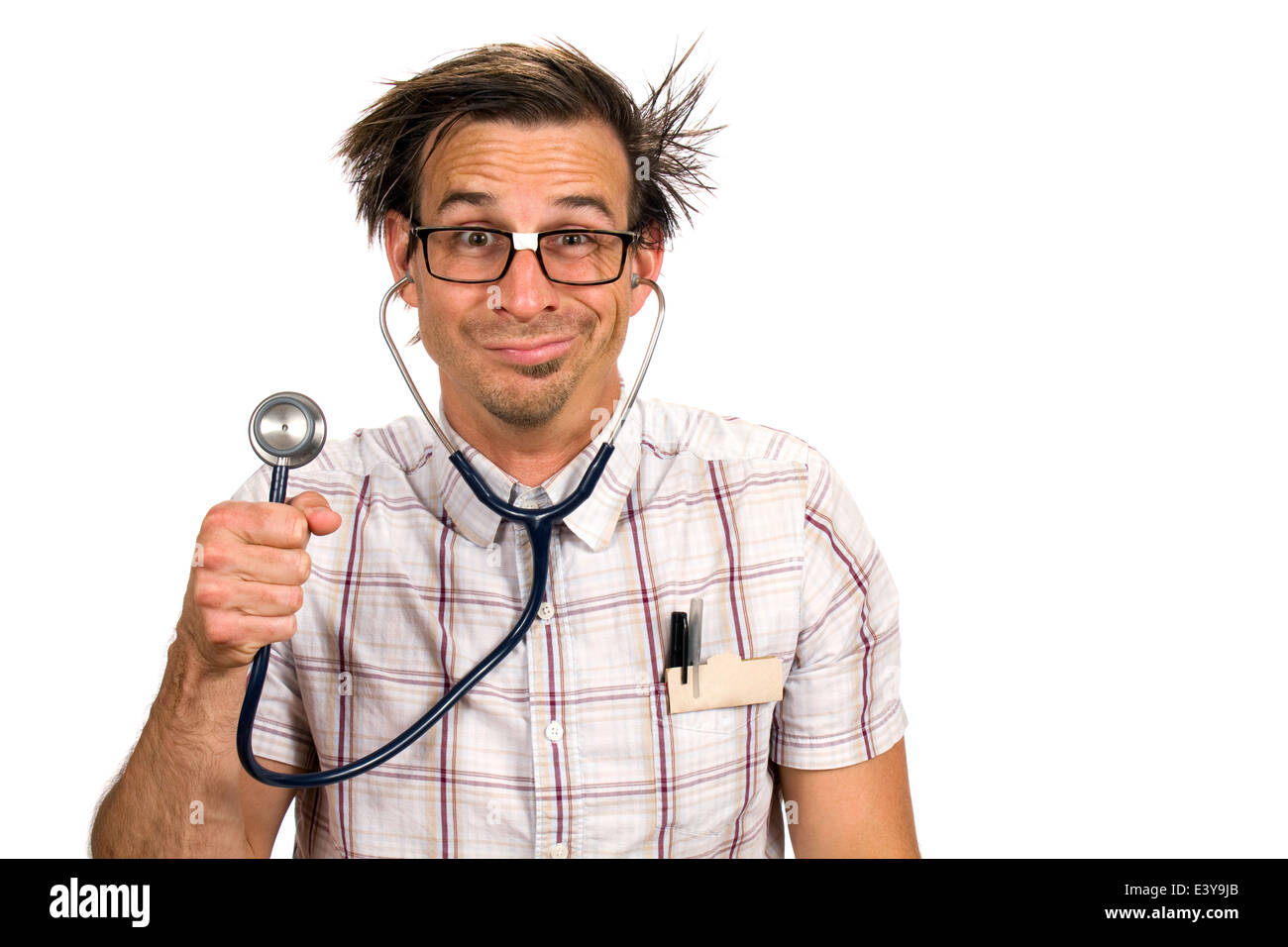 Nerdy doctor with a silly facial expression holds up a stethoscope. Stock Photo