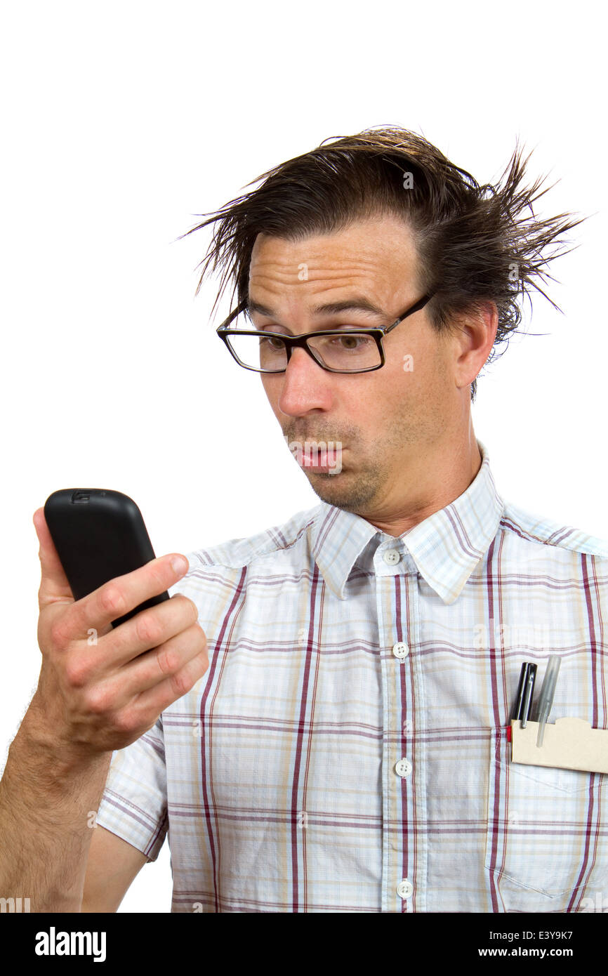 Nerdy looking man makes a weird and surprised facial expression while viewing his smartphone. Stock Photo