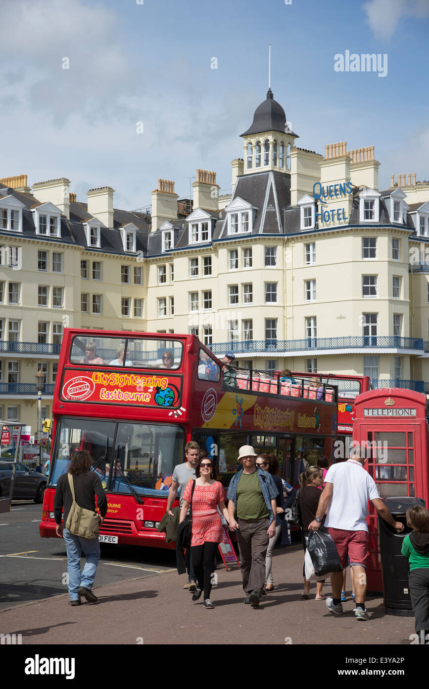 Hop on Hop off tour bus waiting for passengers at departure point Eastbourne seafront East Sussex England UK Stock Photo
