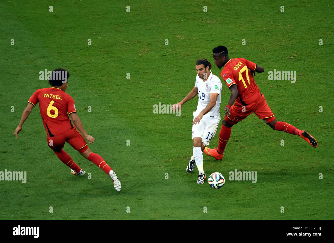 Salvador, Brazil. 1st July, 2014. Graham Zusi (C) of the U.S. vies with Belgium's Divock Origi (R) and Axel Witsel during a Round of 16 match between Belgium and the U.S. of 2014 FIFA World Cup at the Arena Fonte Nova Stadium in Salvador, Brazil, on July 1, 2014. Credit:  Guo Yong/Xinhua/Alamy Live News Stock Photo