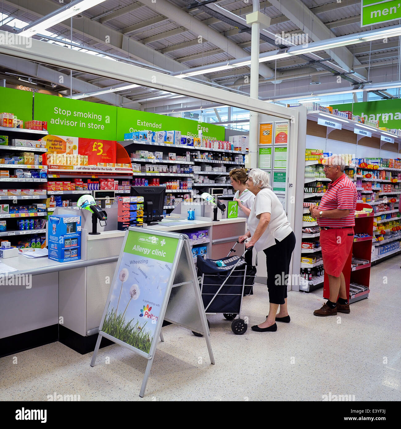 Old people at  pharmacy in ASDA supermarket, UK Stock Photo