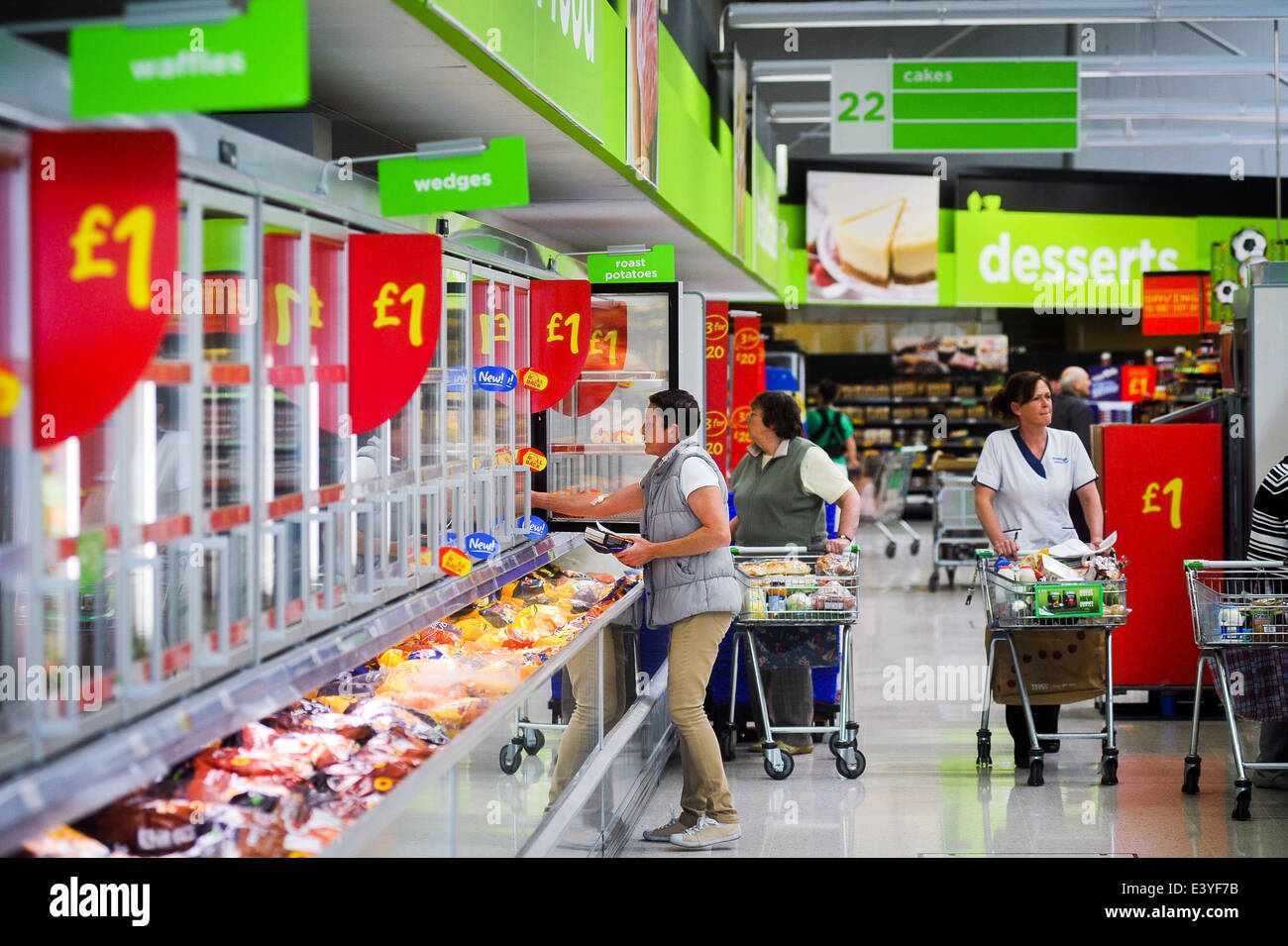 Shoppers looking for bargains in the £1 freezer aisle of ASDA supermarket Stock Photo