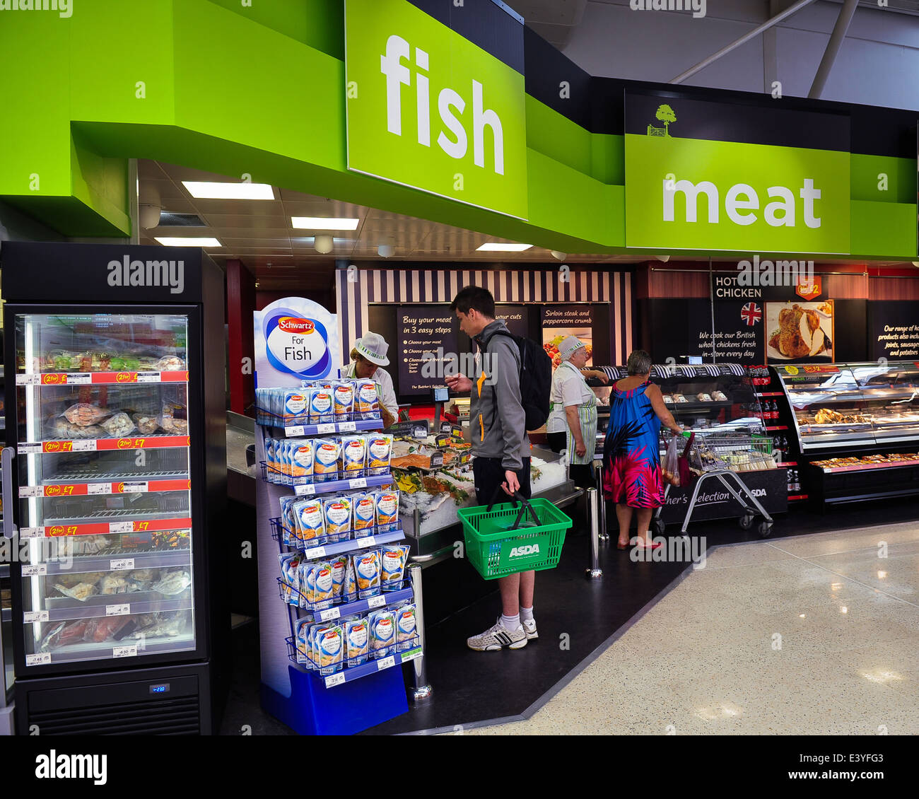young man at fish counter in supermarket Stock Photo