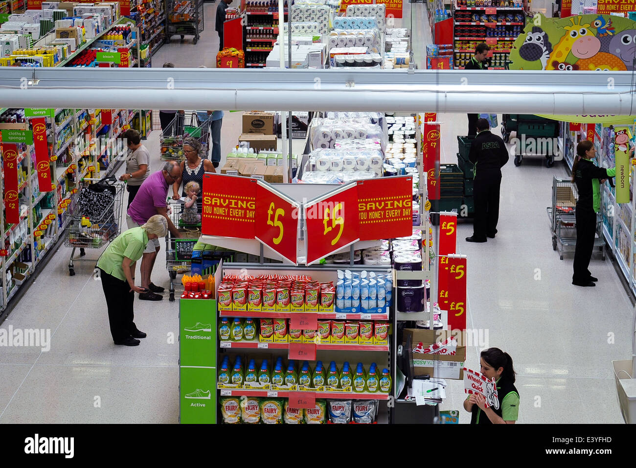 interior of supermarket showing staff re-stocking shelves Stock Photo
