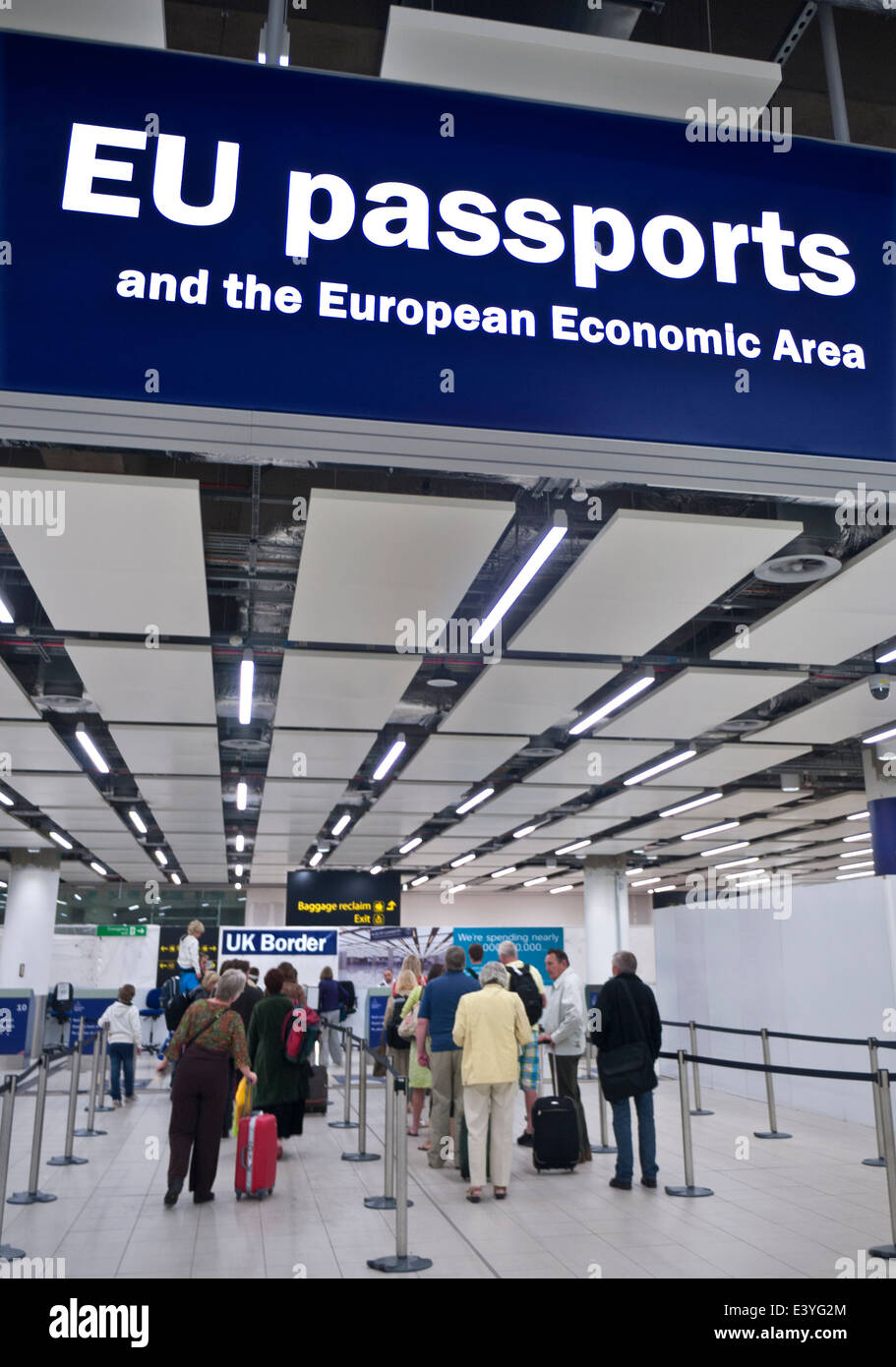 UK Border Control for EU passports at London Gatwick airport with arriving passengers waiting immigration and security clearance Stock Photo