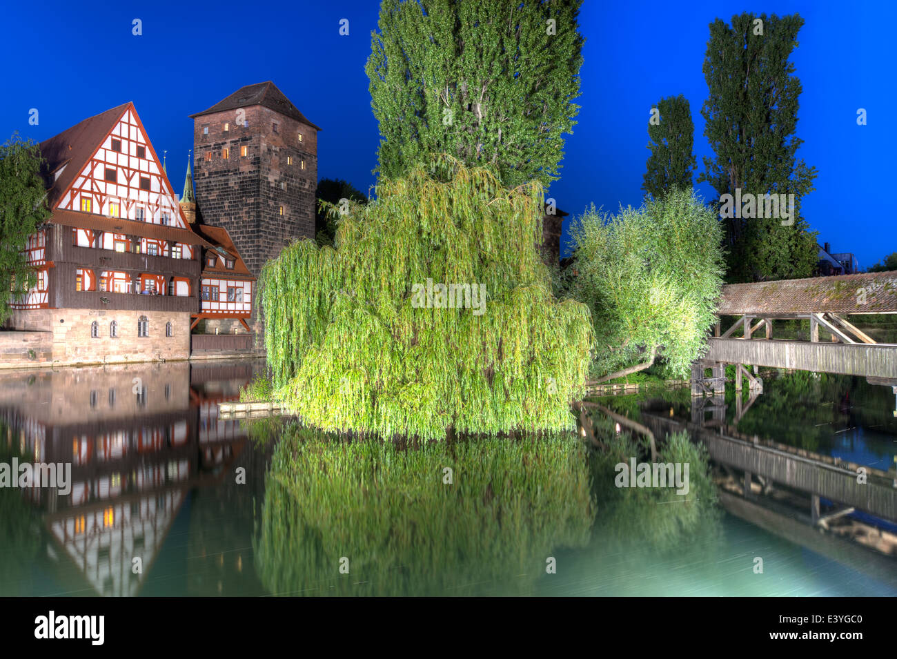 From left to right, the famous Weinstadel, Wasserturm (Water Tower) and Henkersteg (Hangman's Bridge) over the river Pegnitz. Stock Photo