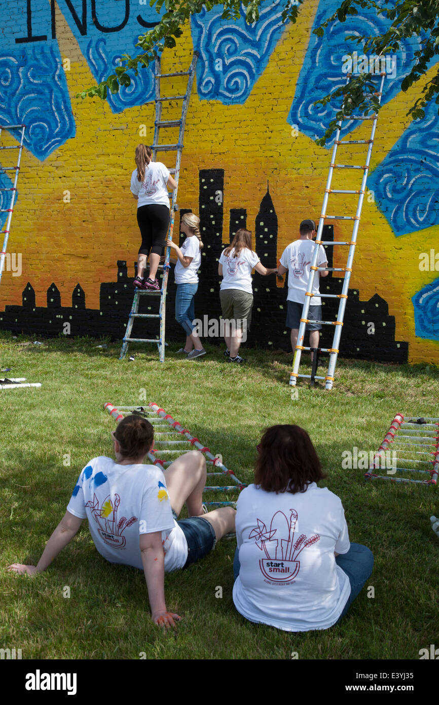 Volunteers paint the wall of a vacant building in Detroit. Stock Photo