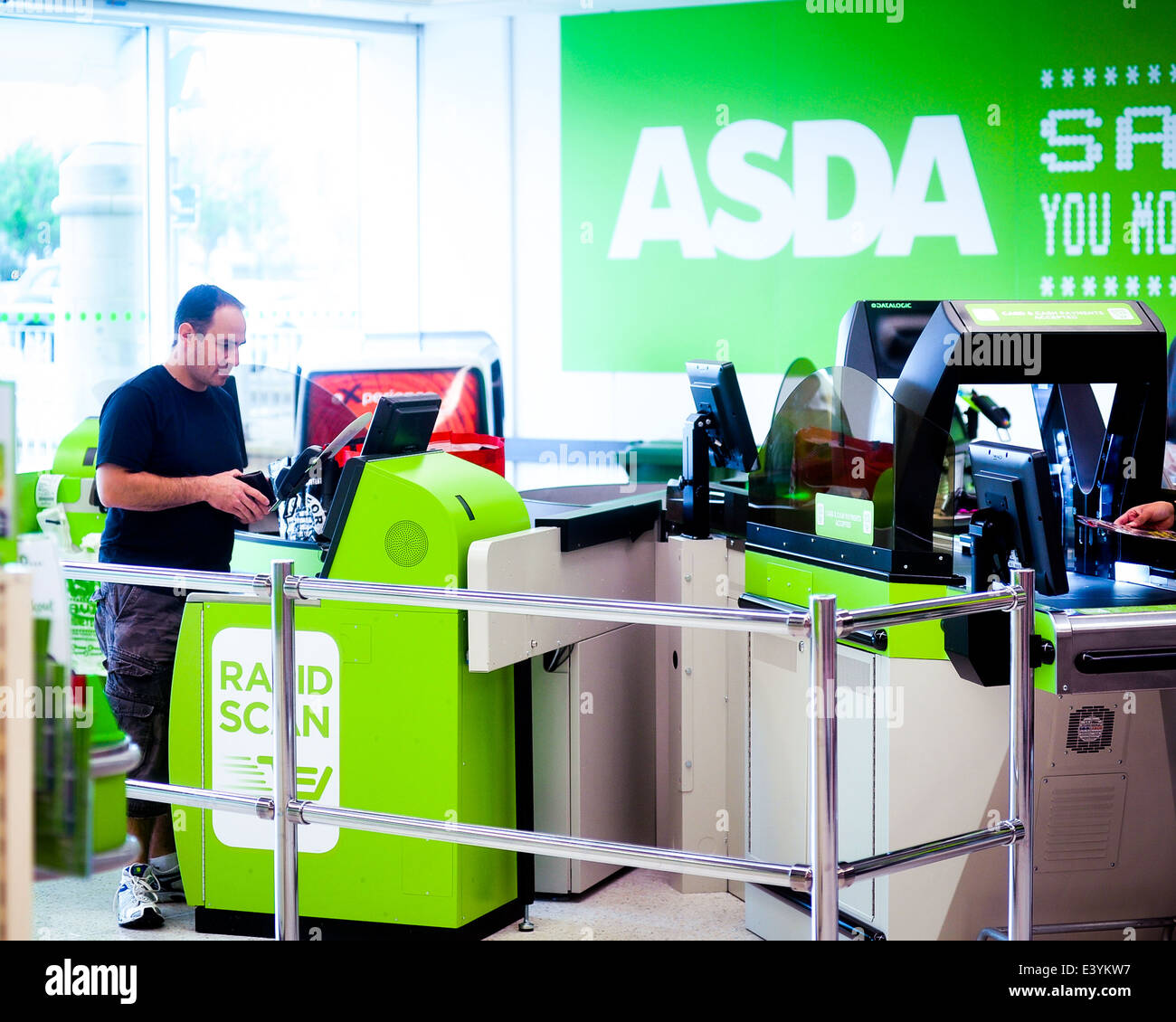 customer at a rapid scan machine at asda Stock Photo Alamy