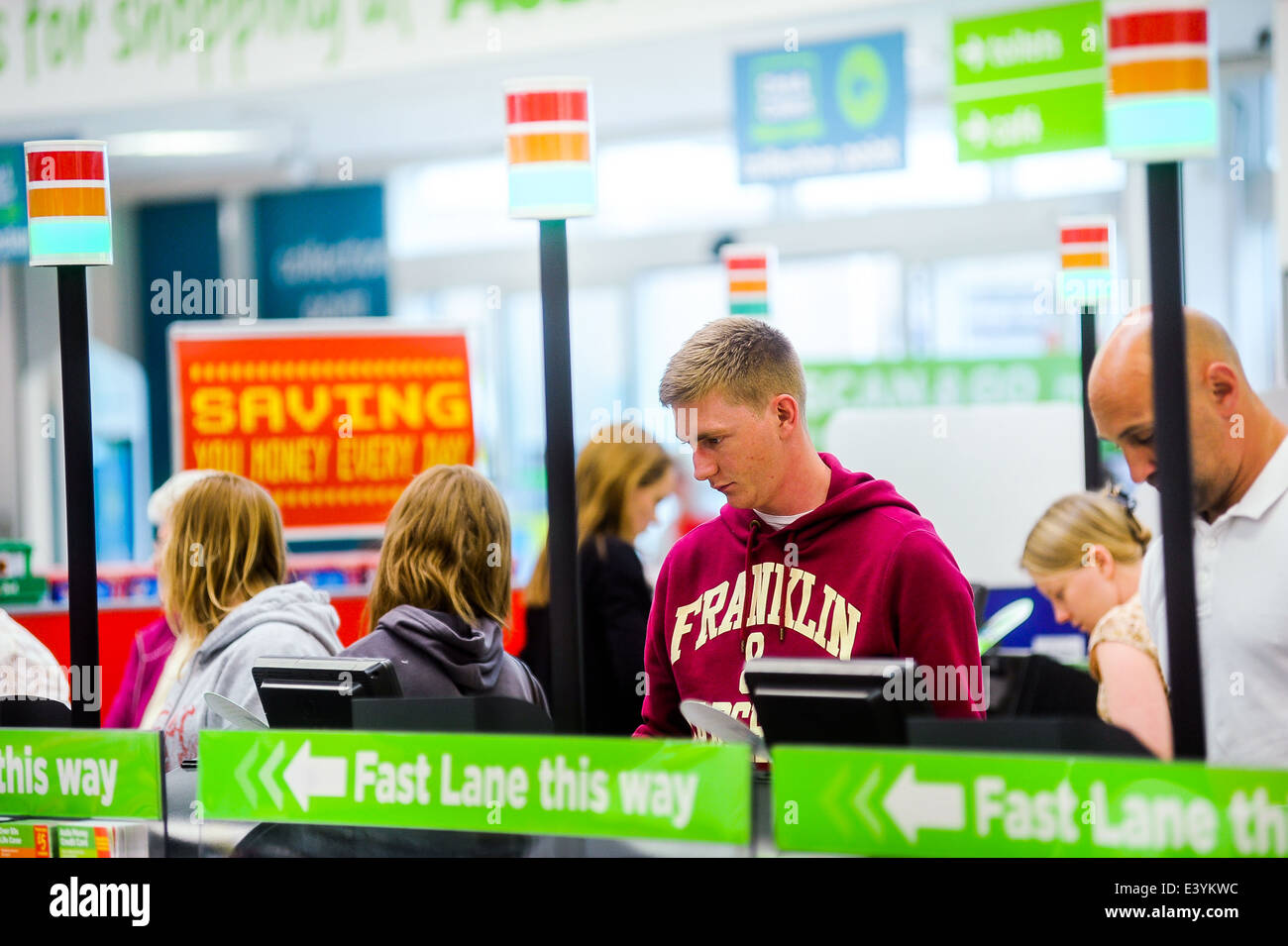 customers at the self service checkouts at a supermarket Stock Photo