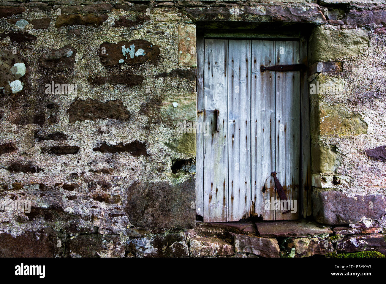 Old door set in old stone wall Stock Photo - Alamy